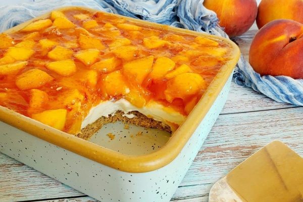 Peach cheesecake recipe in a baking dish.