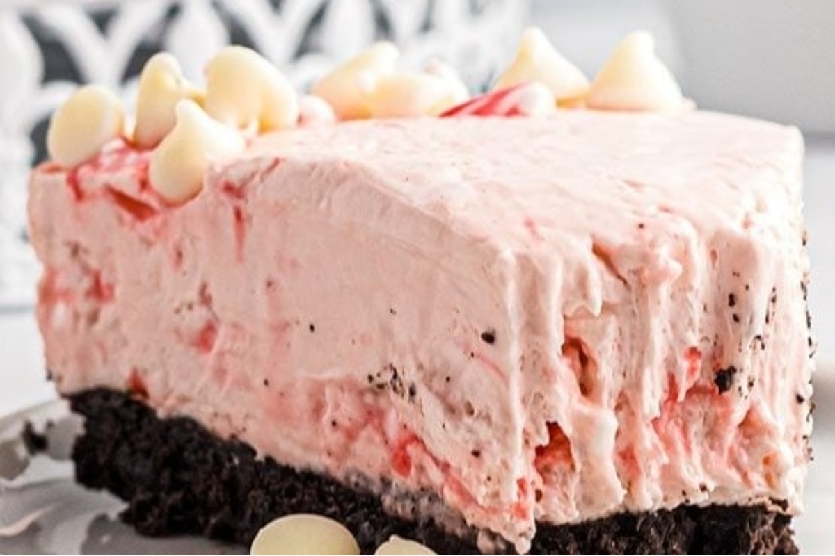 A festive slice of pink peppermint ice cream cake, perfect for the holidays.