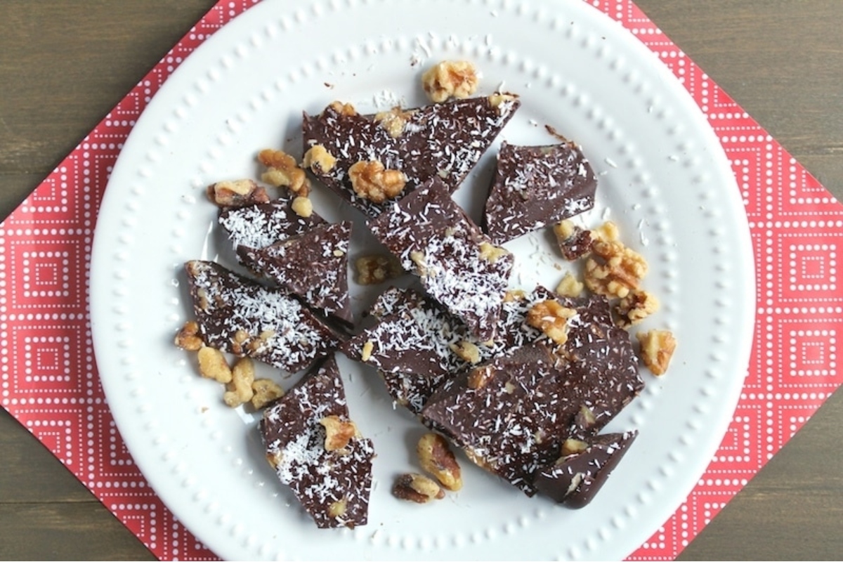 Christmas chocolate fudge with coconut and walnuts on a plate.