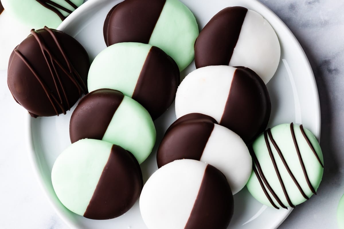 No Bake mint chocolate dipped desserts on a white plate.