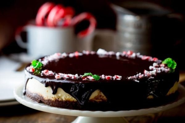 A decadent Christmas dessert, a chocolate peppermint cheesecake elegantly placed on a white plate.