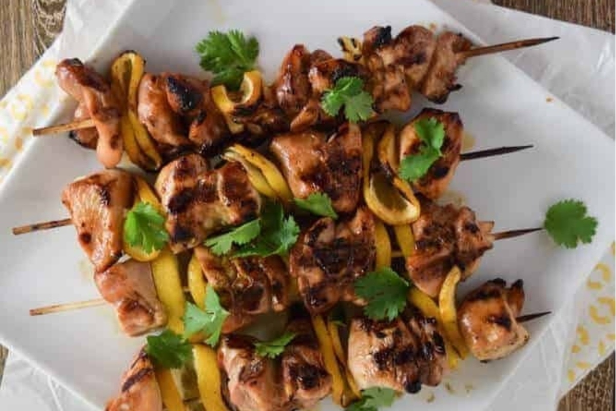 Hawaiian-inspired chicken skewers on a white plate.