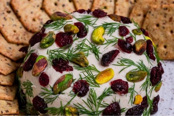 A delectable cheese ball recipe that combines the tangy flavors of cranberries and delightful crunch of pistachios, perfect for serving with a side of crackers.