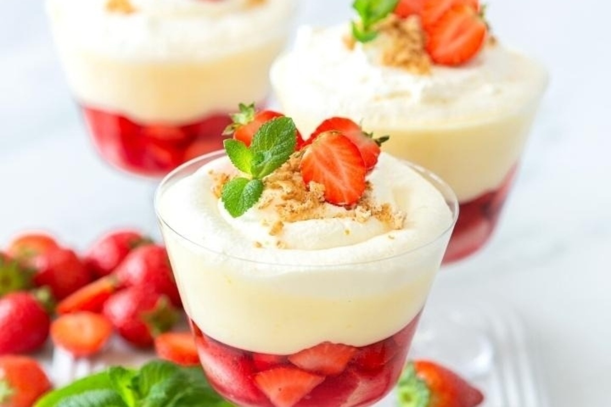 Strawberry trifles in a glass with whipped cream and strawberries.