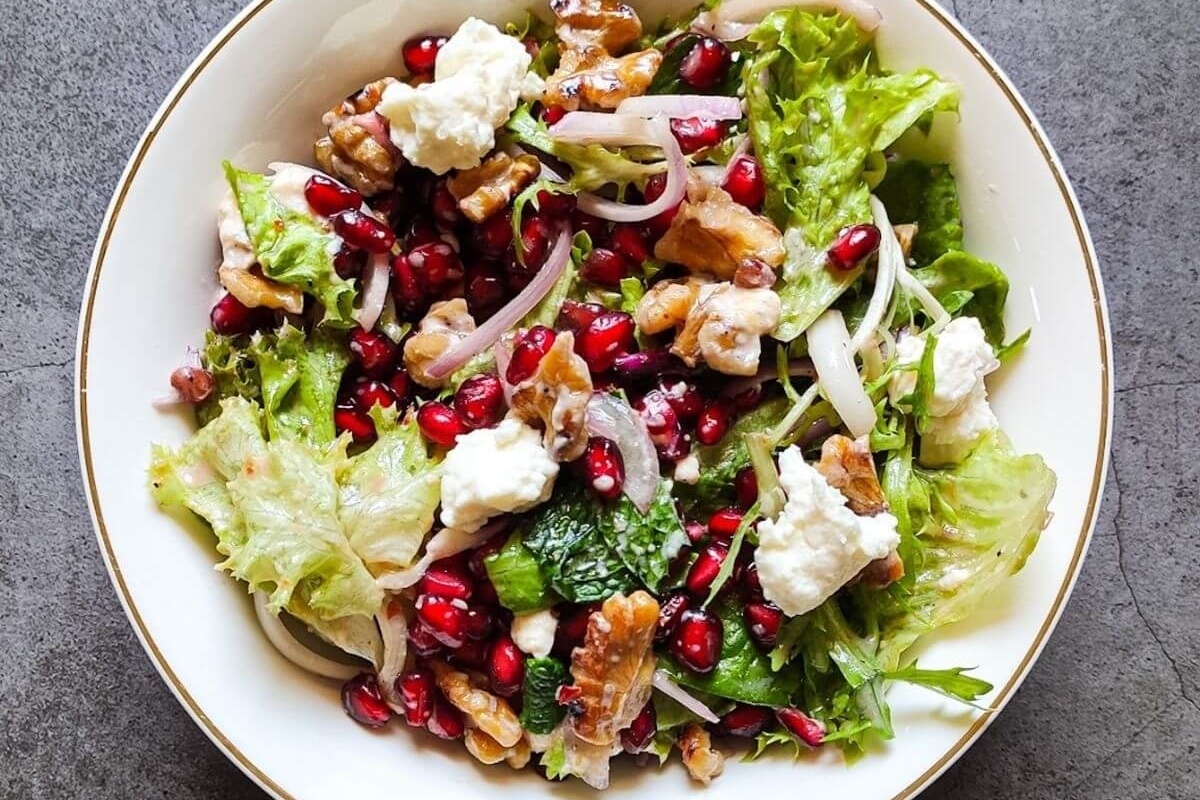 Looking for delicious recipes incorporating pomegranate? Try this mouthwatering bowl of salad featuring the perfect combination of pomegranate, walnuts, and feta cheese.