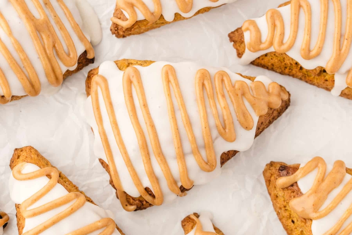Starbucks' holiday-inspired pumpkin scones are a delightful treat topped with a delicious icing and drizzle.