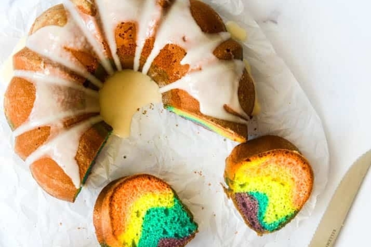 Rainbow bundt cake with icing.