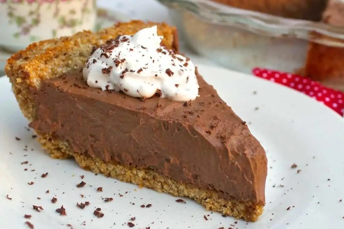 A decadent slice of chocolate pie on a plate, perfect for the holidays.