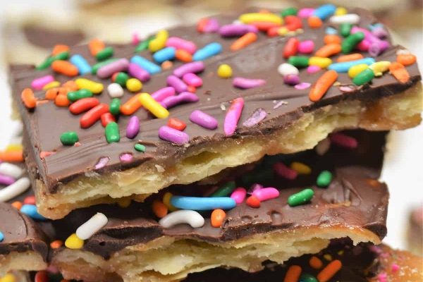 A stack of chocolate bars with sprinkles on top.