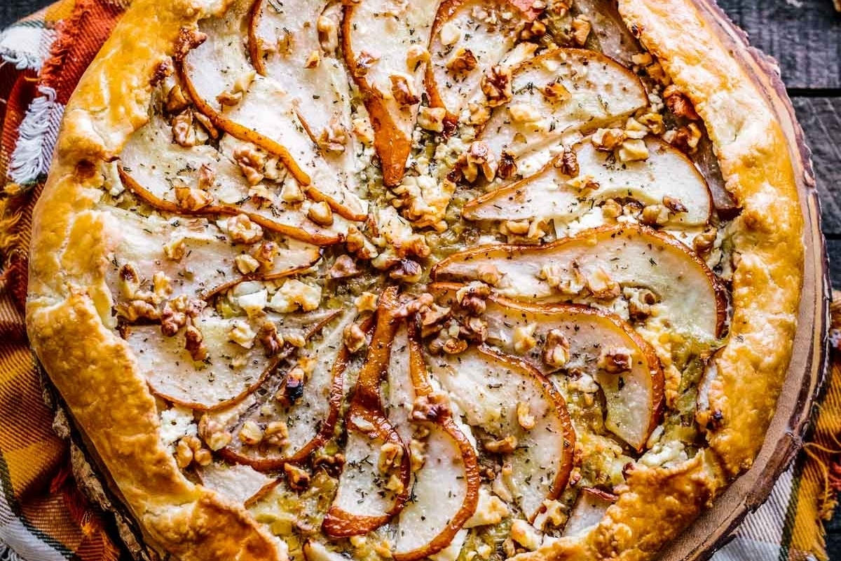 A savoury pie with pears and walnuts on top.