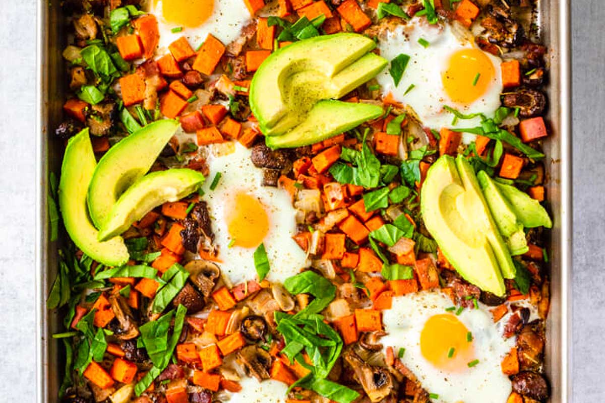 A baking dish with eggs, avocado, and black beans.
