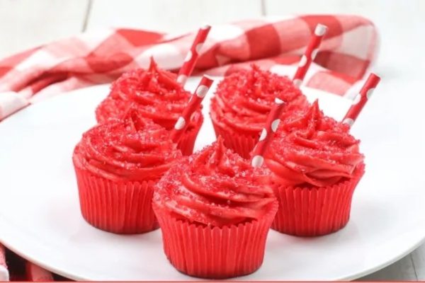 Red velvet cupcakes recipes on a white plate.