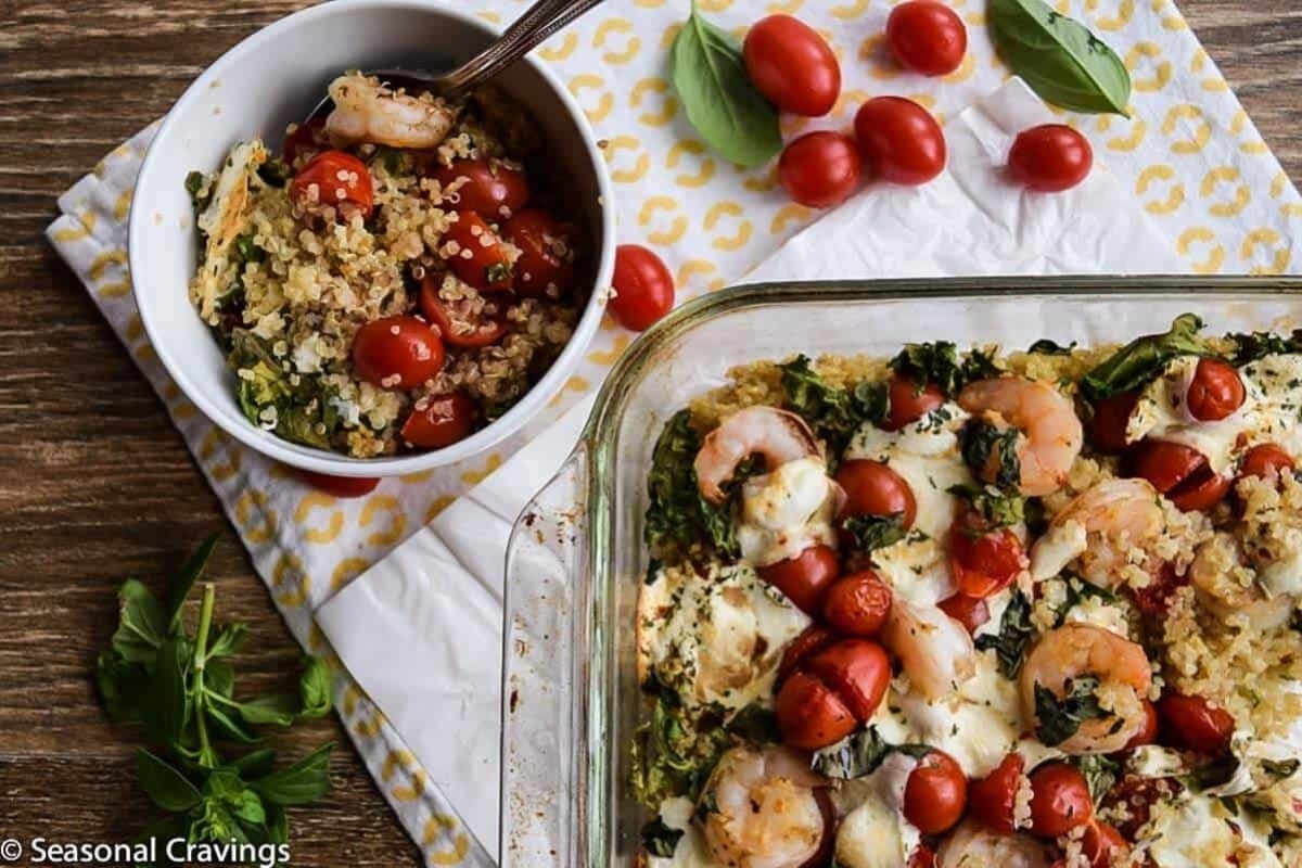 A Feast casserole dish with shrimp, tomatoes and kale.