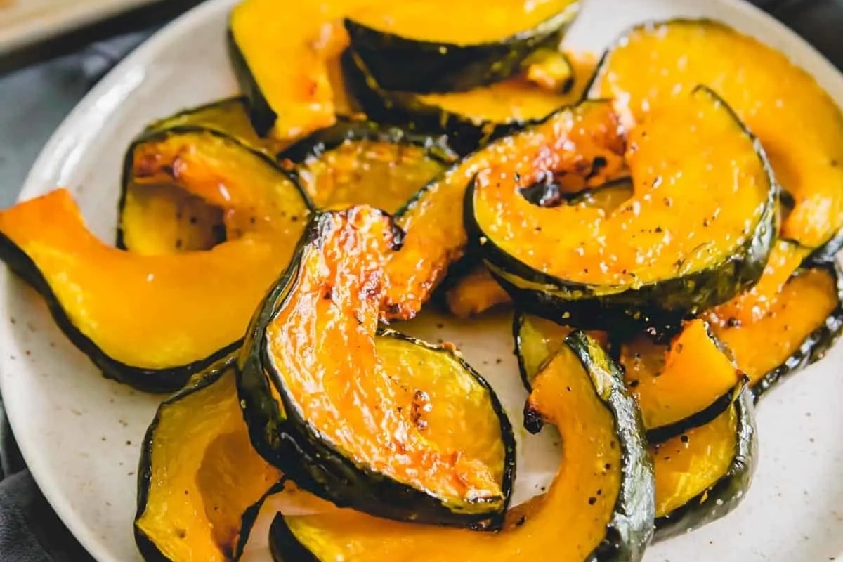 Roasted butternut squash, a delicious and nutritious side dish, perfectly presented on a white plate.