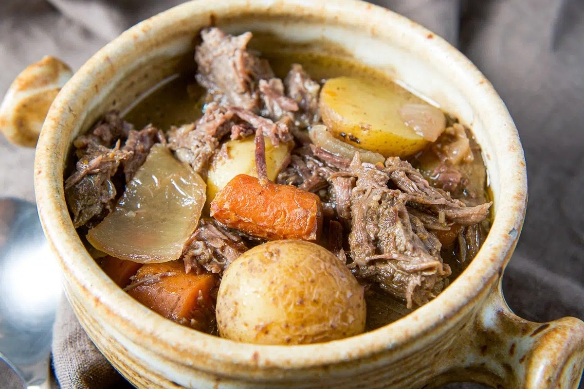 A slow cooker beef stew with potatoes and carrots.