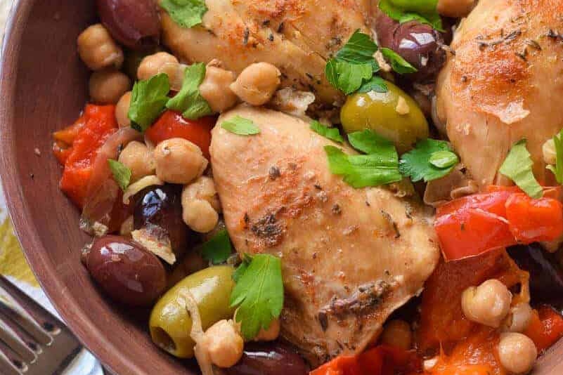 Chicken and chickpeas in a brown bowl.