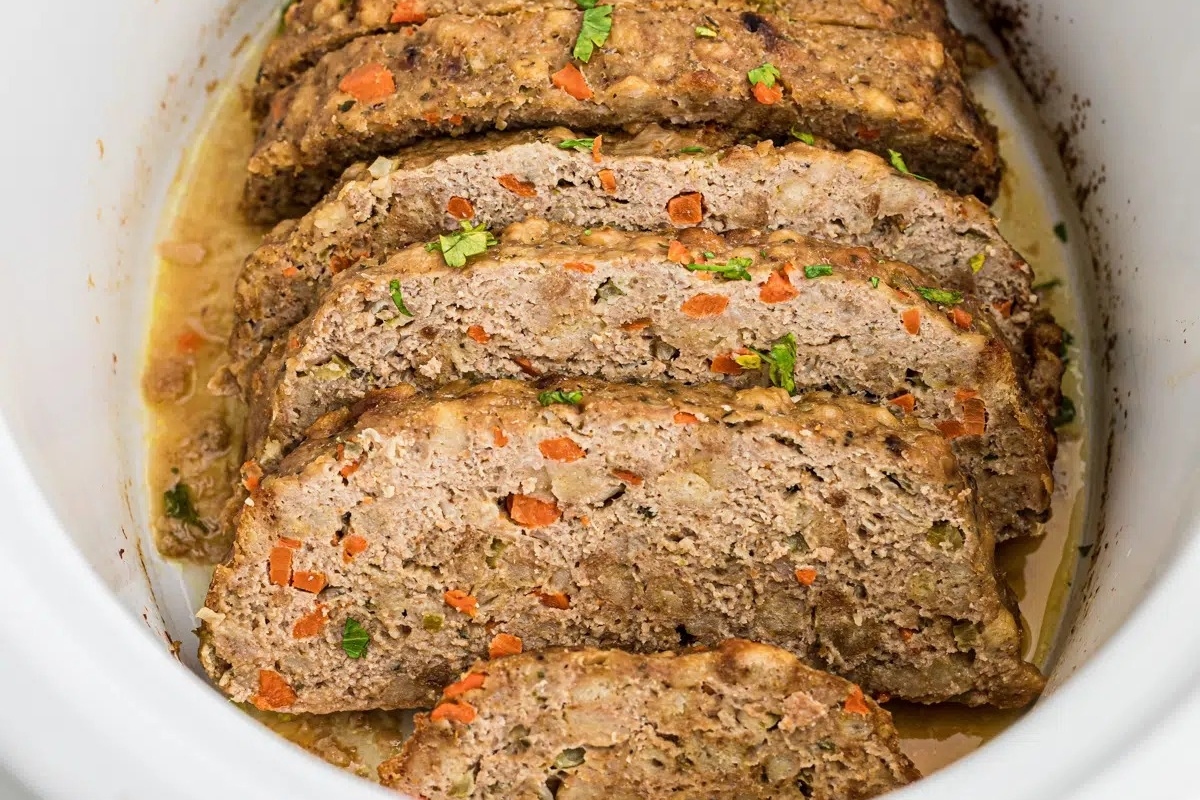 Country-style sliced meatloaf in a slow cooker.