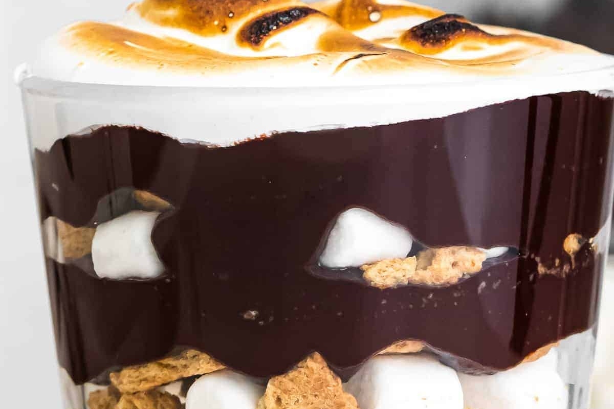 Chocolate s'mores trifle in a glass with marshmallows. This delectable treat combines all the flavors of a classic s'mores dessert layered in a glass, creating a delightful