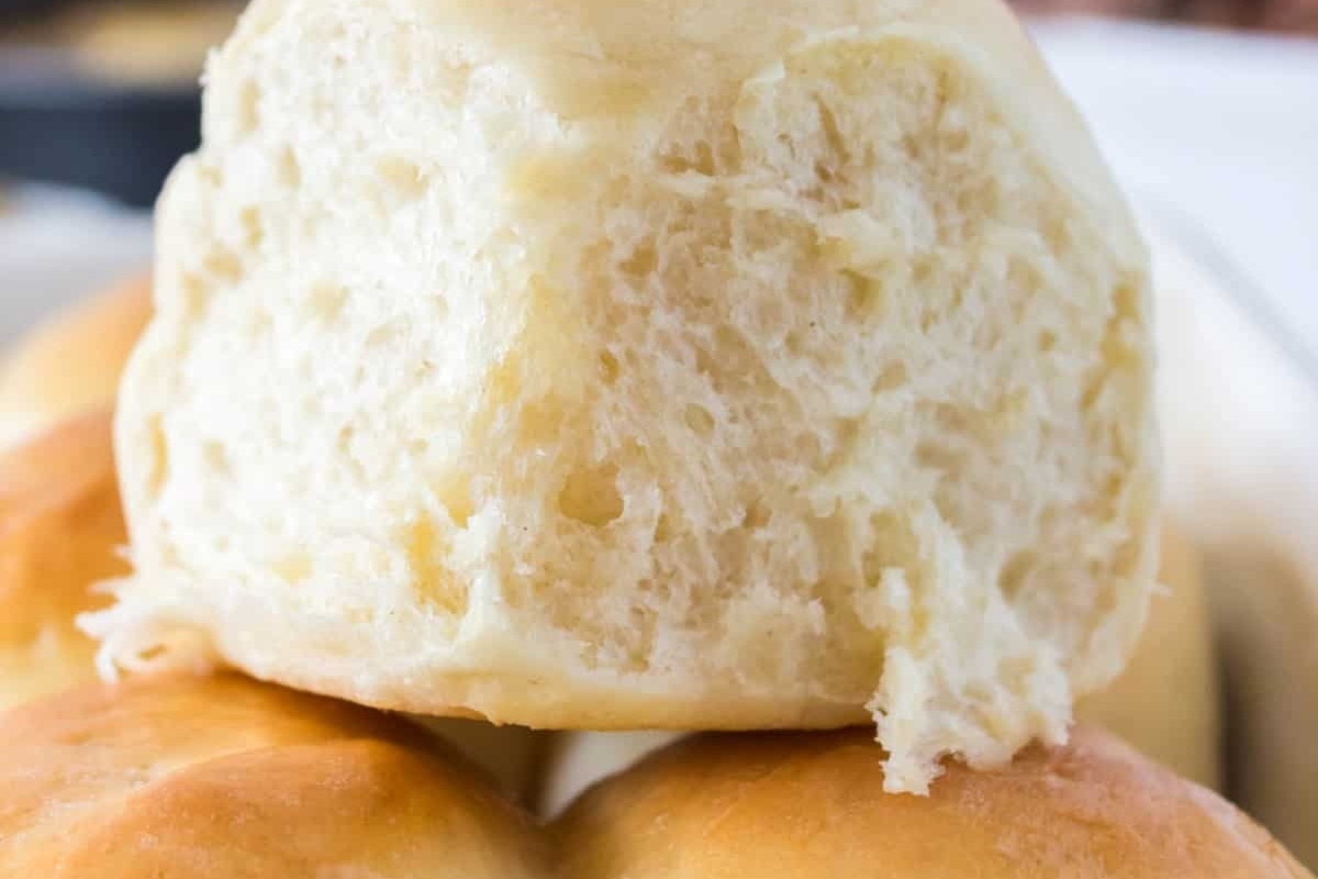 A close up of a bun on a plate, perfect for recipes or enjoying as part of a bread basket.