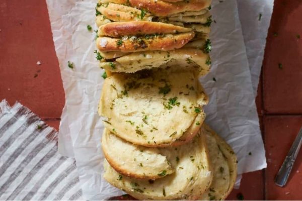 A loaf of bread with herbs on it.