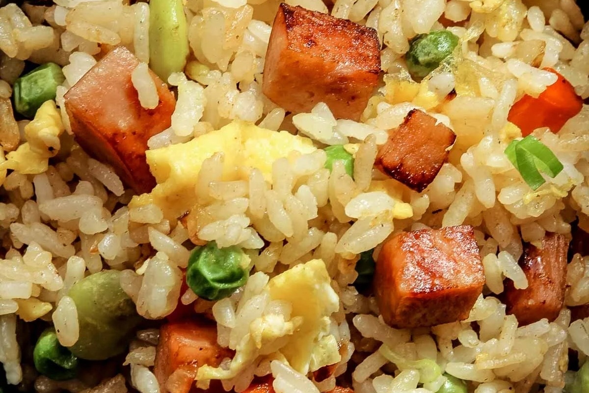 A close up of Hawaiian Inspired fried rice with vegetables and meat, perfect for a Luau celebration.