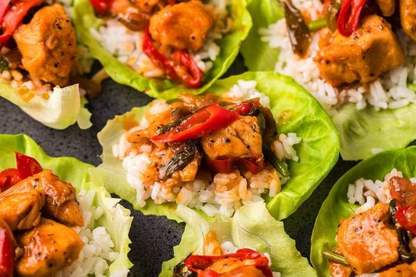 Spicy Gochujang Chicken Stir Fry served with rice in lettuce leaves.