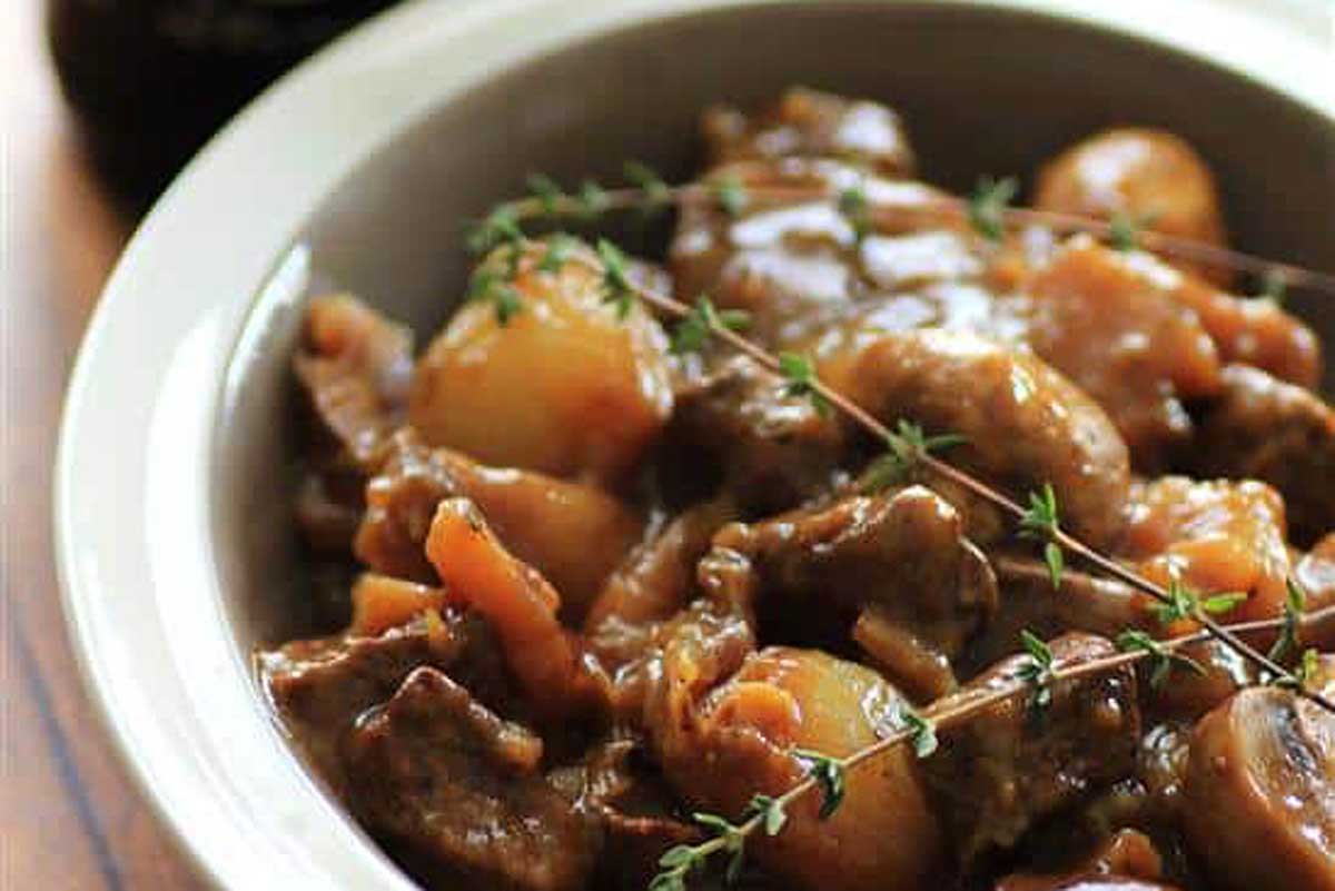 Irish stew with potatoes and sprigs of thyme.