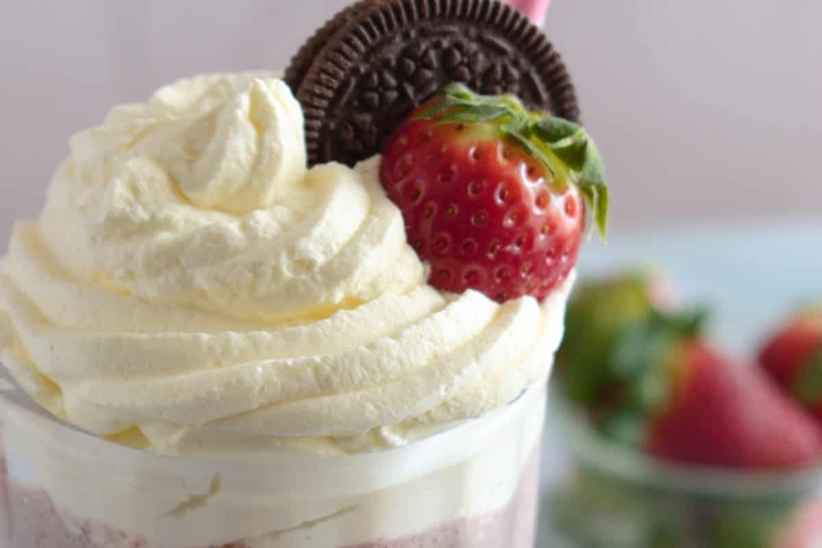 A delicious milkshake recipe combining oreo cookies, fresh strawberries, and a generous dollop of whipped cream.
