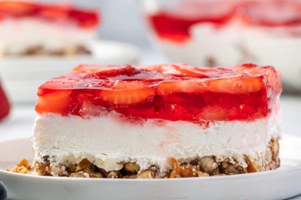 A slice of strawberry cheesecake on a plate, perfect for dessert lovers.
