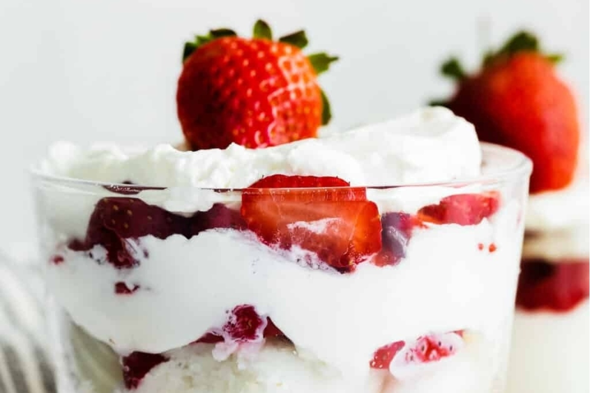 Trifles are a delightful dessert made with layers of strawberry, whipped cream, and fresh strawberries.