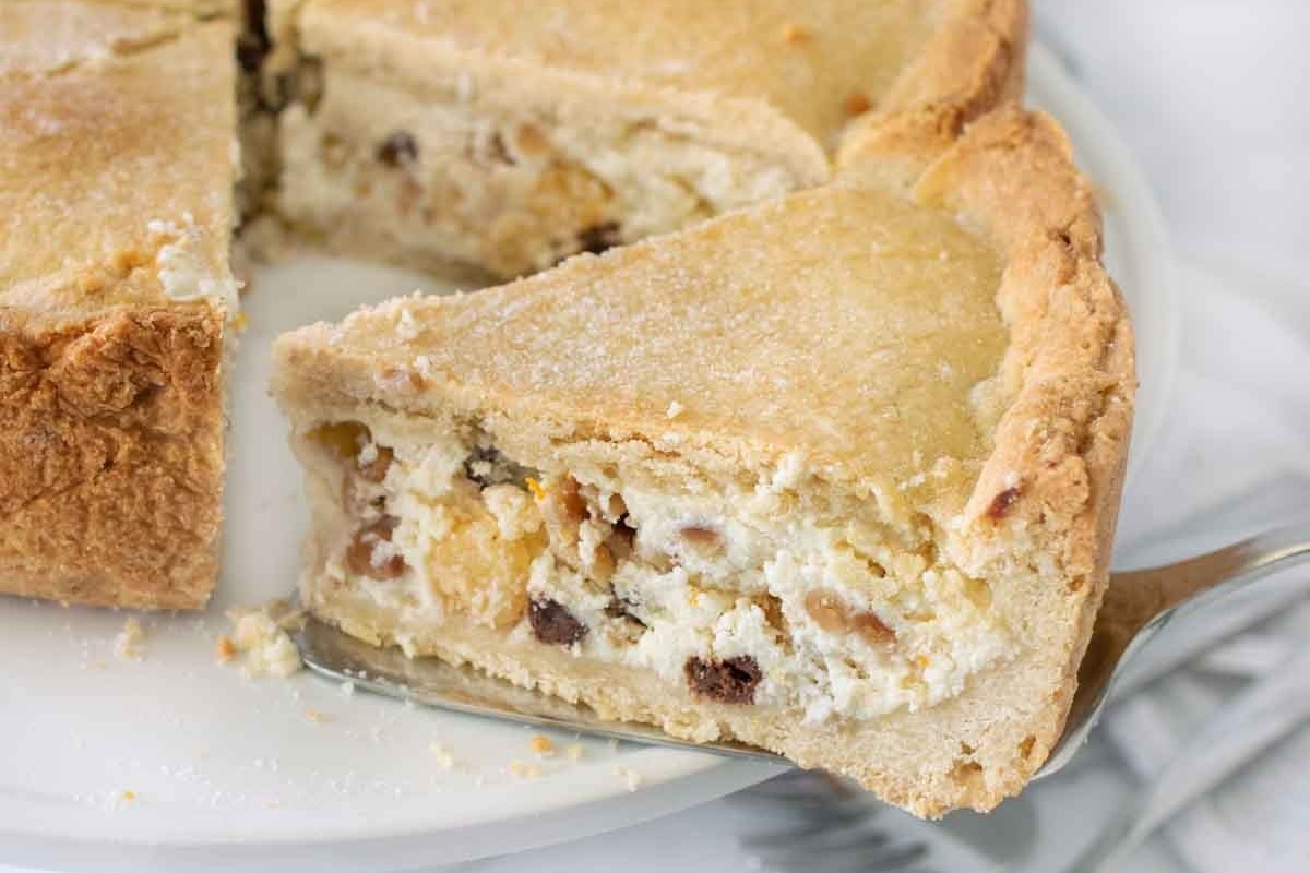 An Italian Dessert pie with a slice taken out of it.