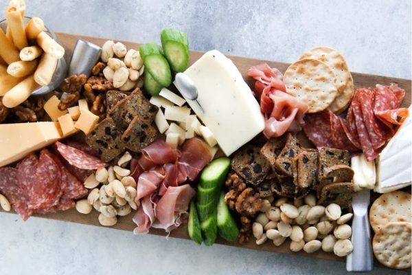 A festive charcuterie board showcasing an assortment of meats, cheeses, and crackers perfect for a Christmas celebration.