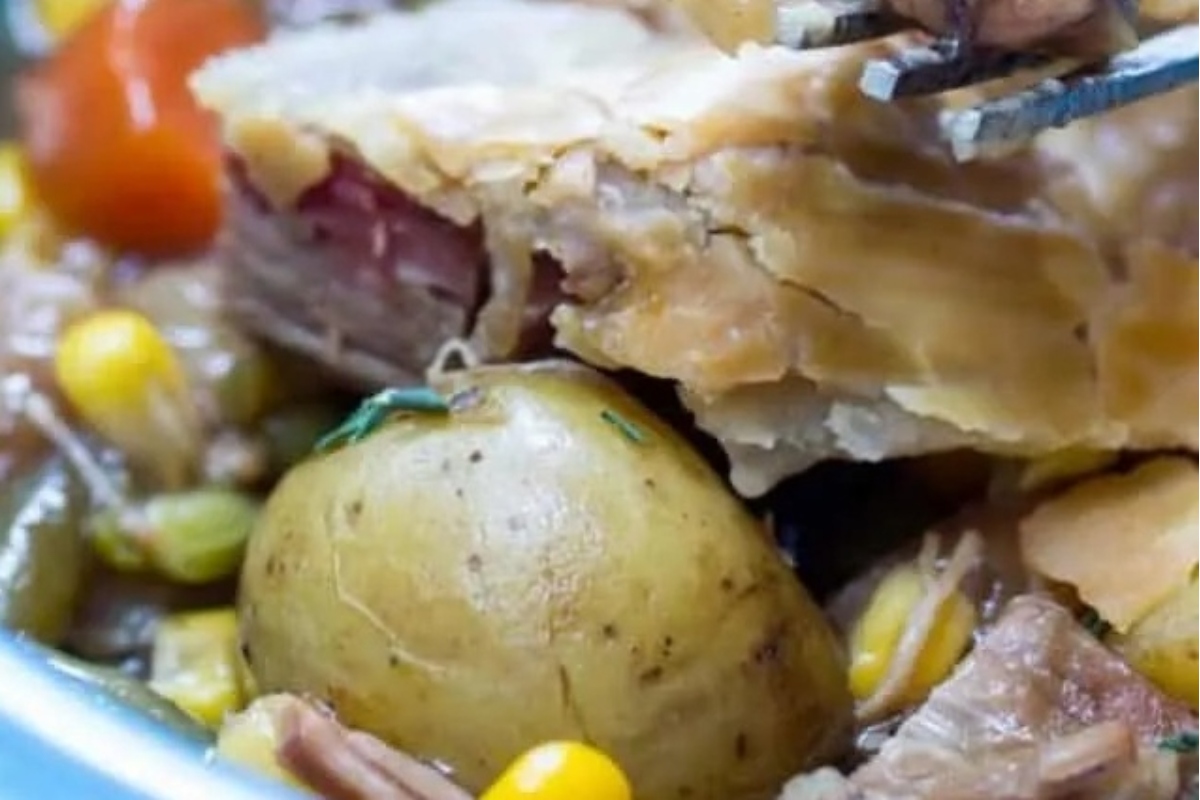 A savory pie filled with meat, potatoes, and vegetables.