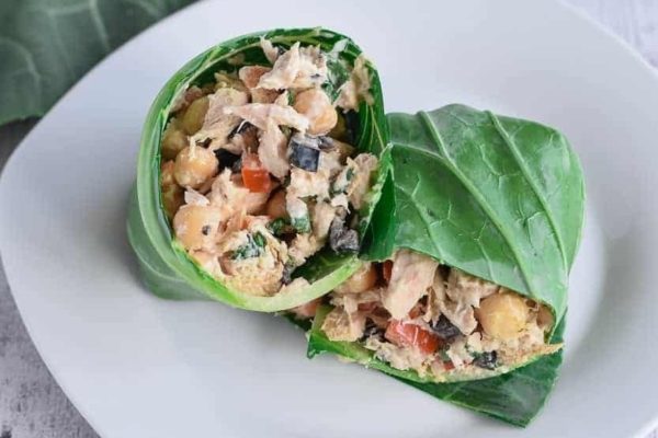 A meal prep with two wraps filled with chicken and vegetables, perfect for lunches.
