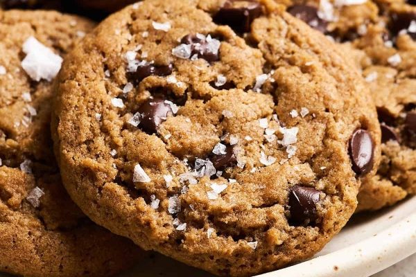 A bowl of chocolate chip cookies with sea salt.