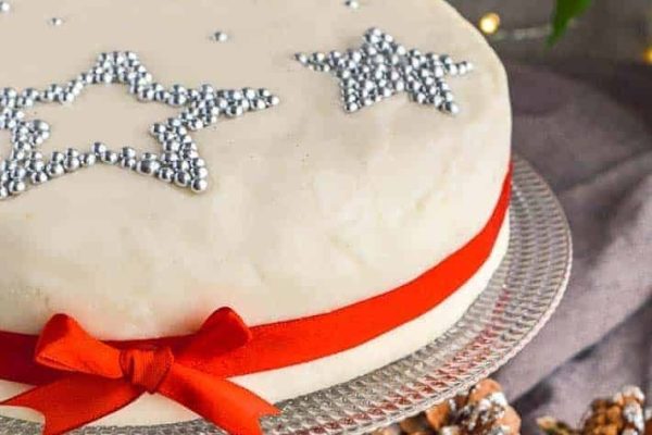A traditional Christmas cake decorated with red and white stars.