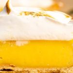 A slice of lemon pie with meringue on top.