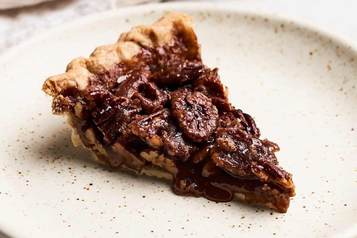 A delectable slice of pecan pie on a plate.
