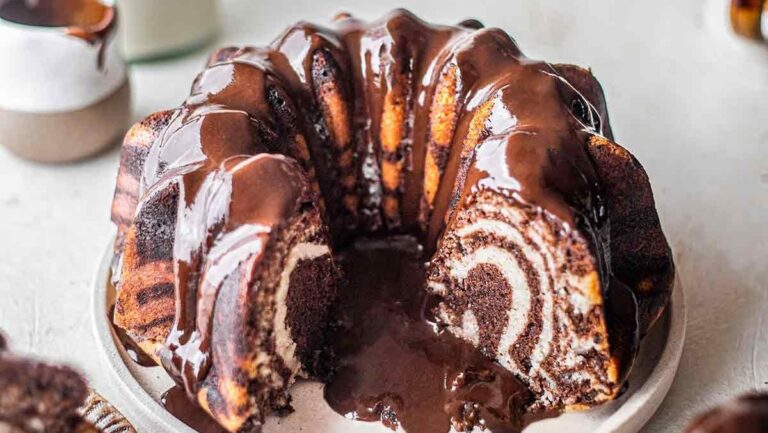 A chocolate bundt cake with a slice taken out.