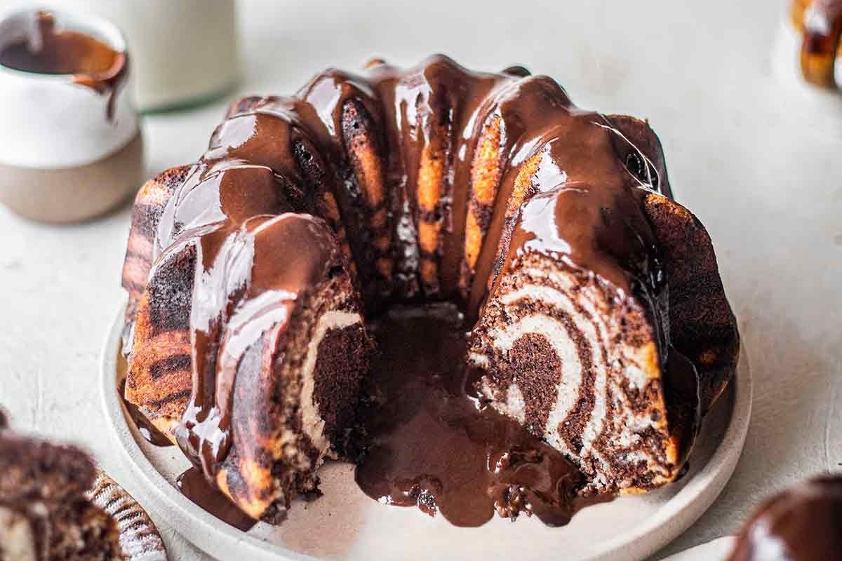 A chocolate bundt cake with a slice taken out.