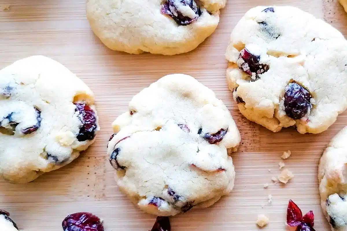 Cranberry chocolate chip cookies on a cutting board.