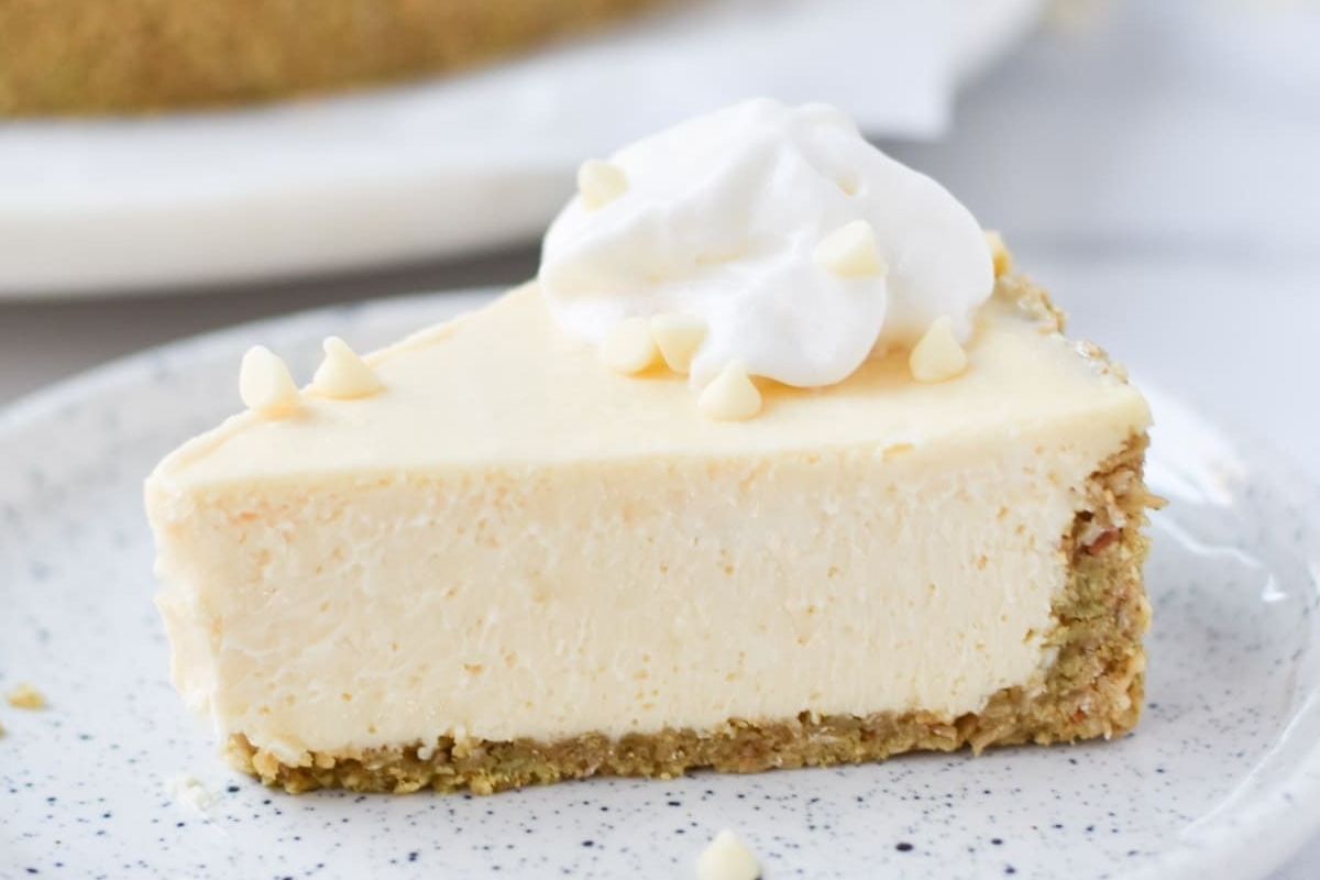 A delectable slice of white chocolate cheesecake on a plate.