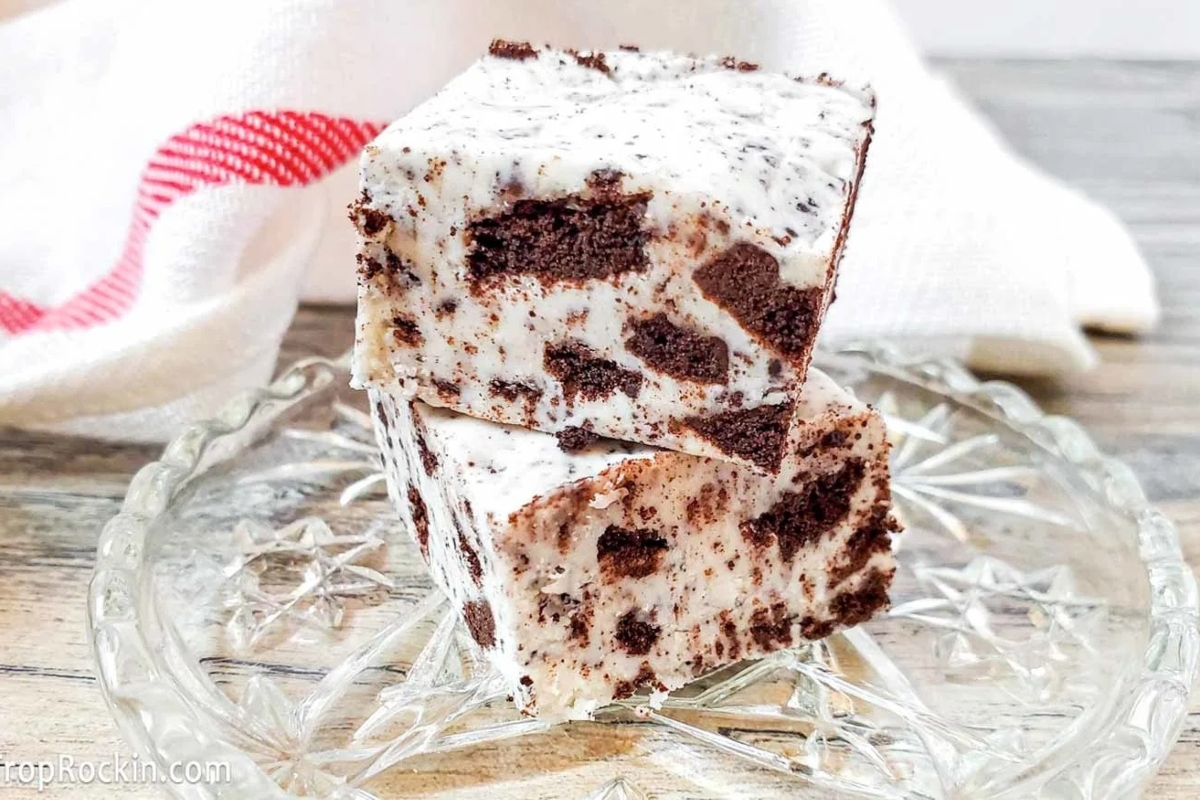 Two squares of chocolate fudge on a glass plate.