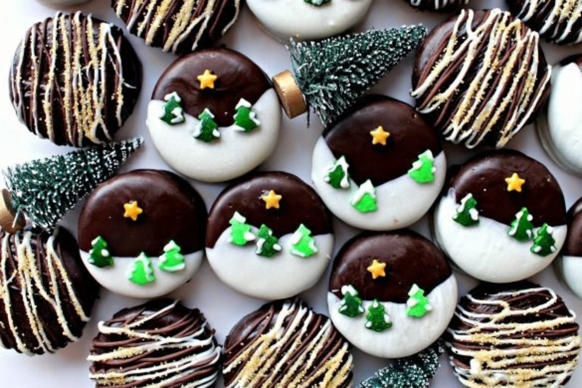 A group of Oreo cookies decorated with Christmas trees and snowflakes.