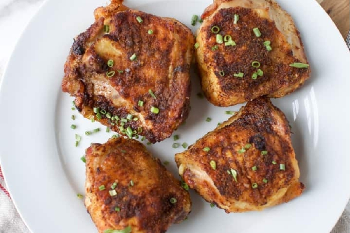 Grilled chicken breasts on a white plate, perfect for winter recipes.