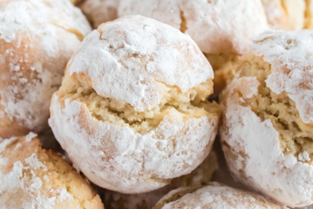 A close up of Italian Dessert powdered cookies with powdered sugar.
