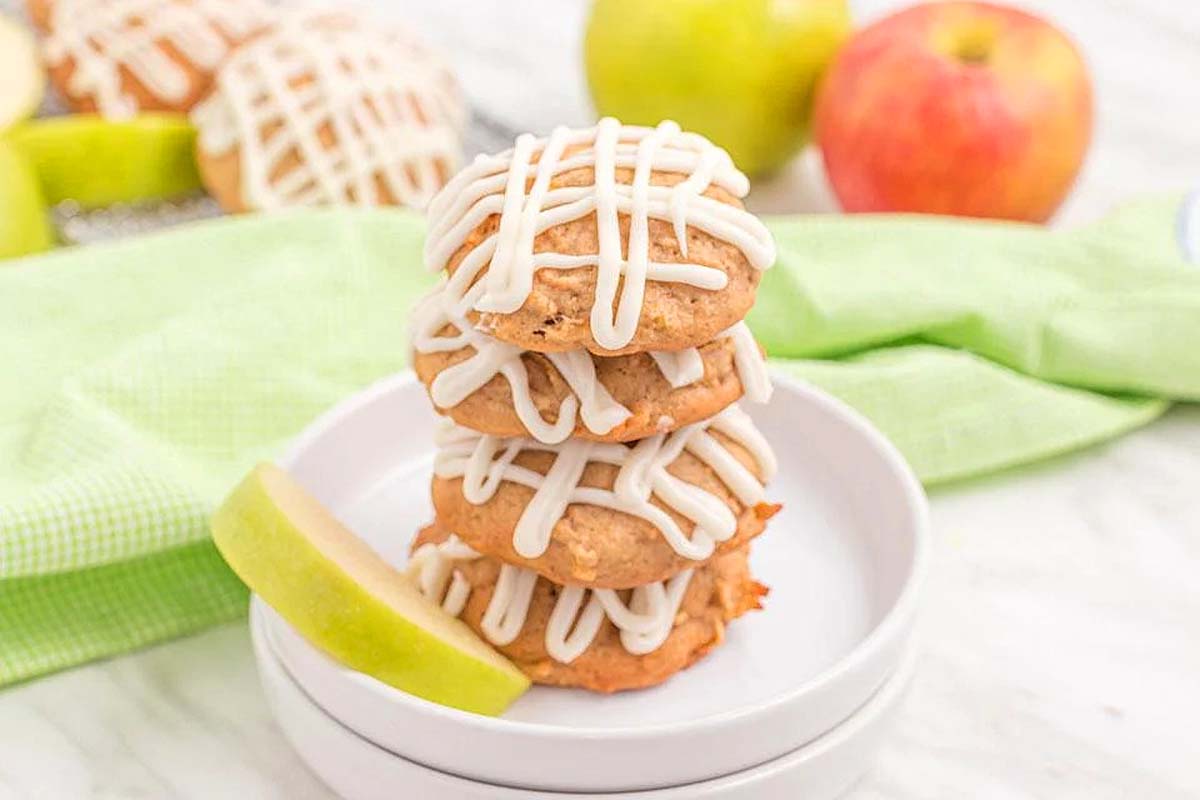 A stack of apple cookies with icing on top, perfect for fall cookie recipes.