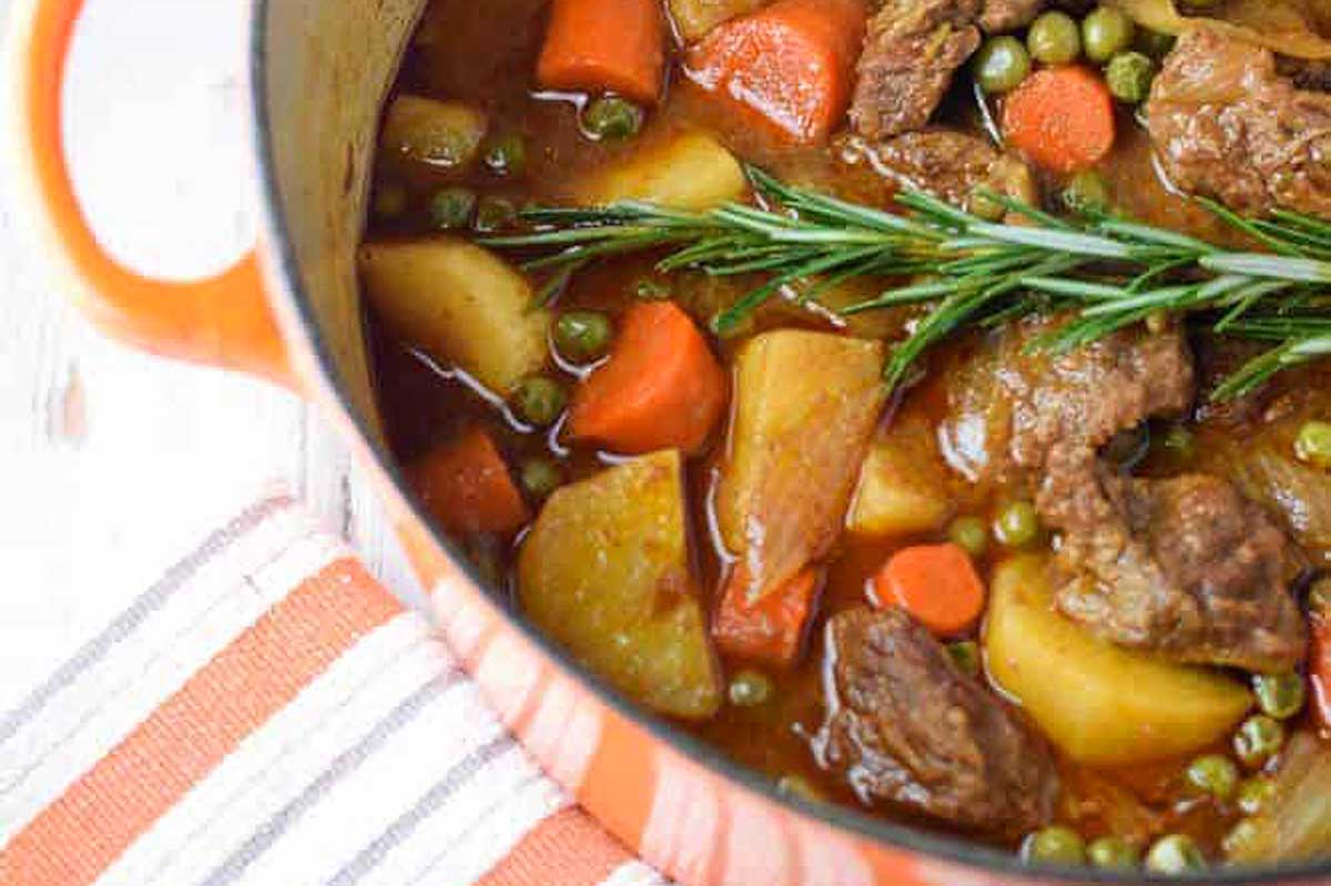 A pot of beef stew with potatoes and carrots.