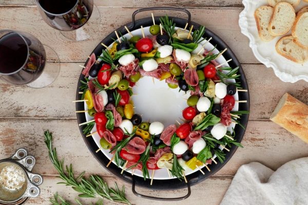 A platter with skewers of meat and vegetables, perfect for a festive Christmas party or a charcuterie board.