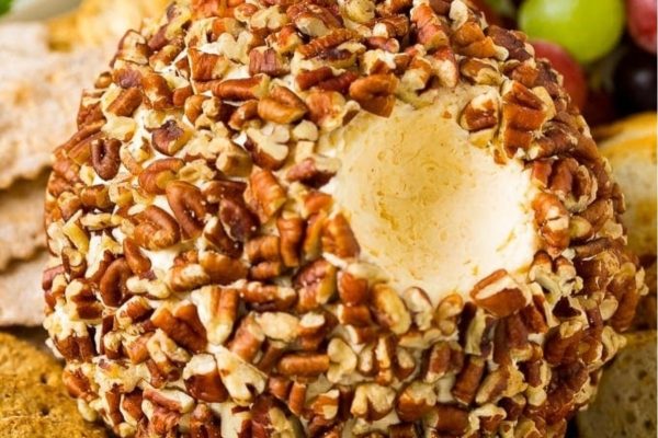Pecan cheese ball recipe with crackers and grapes.